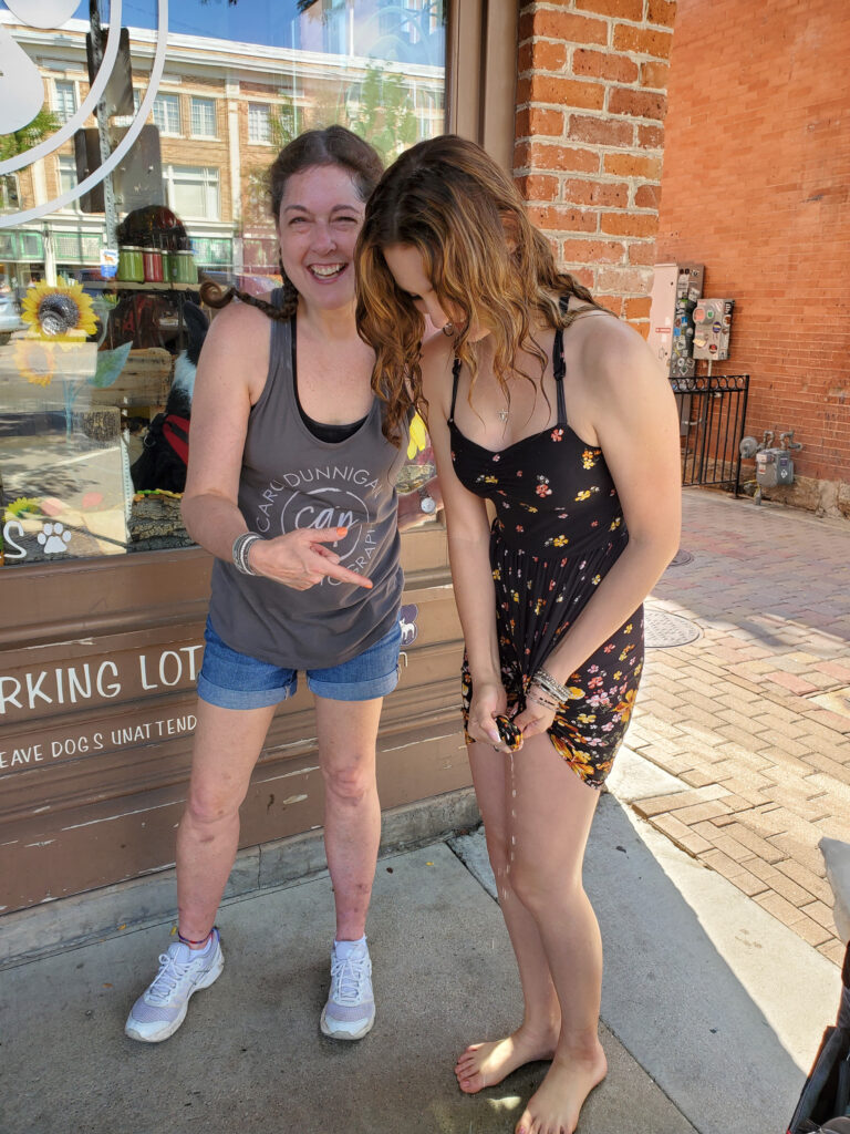 Behind the scenes during a senior photo session in downtown Fort Collins, Colorado after getting wet.