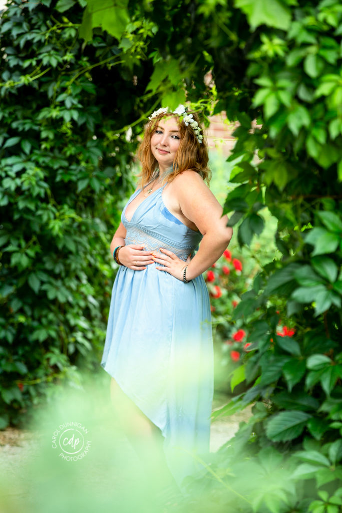 Cassie posing among the plants at the CSU Flower Trial Garden in Fort Collins for her senior pictures