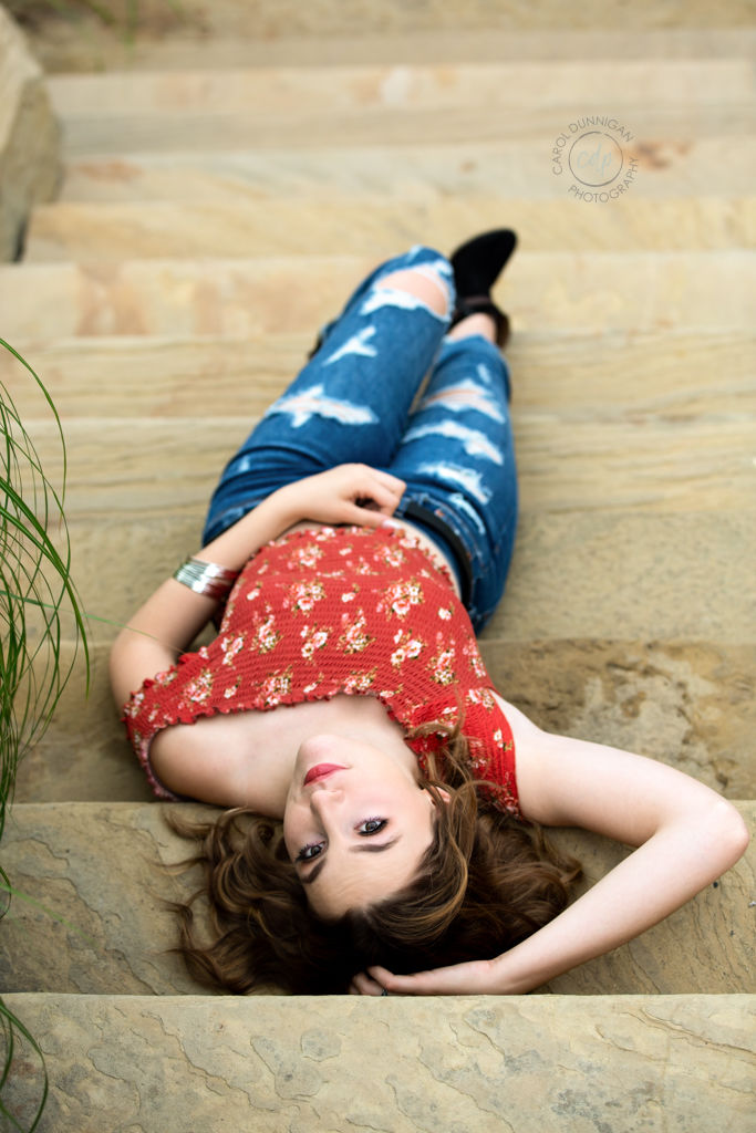 Delaney lying on stone steps at the Rock Garden in Fort Collins for her senior pictures