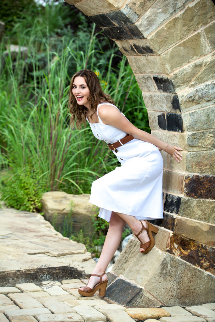 Delaney posing beside the stonework at the Rock Garden in Fort Collins during her senior portrait session