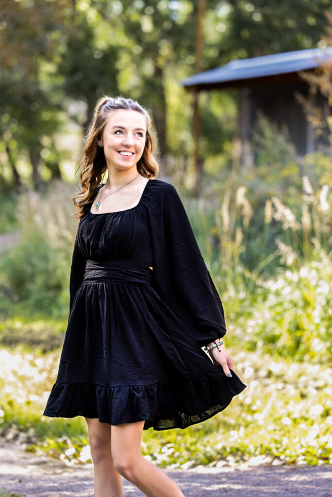 High school senior wearing a black dress during a Loveland Colorado senior portrait session.