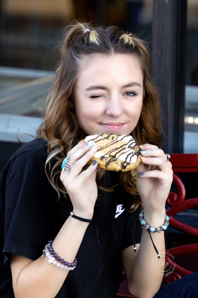 Demy enjoying a cookie during her downtown Loveland senior portrait session