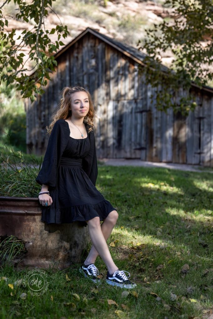 Demy wearing a black dress during her senior pictures near Loveland, Colorado
