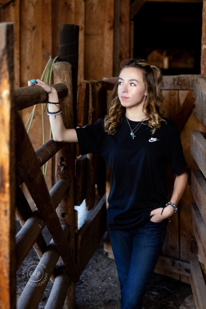 Demy posing in a rustic setting during her Loveland senior portrait session