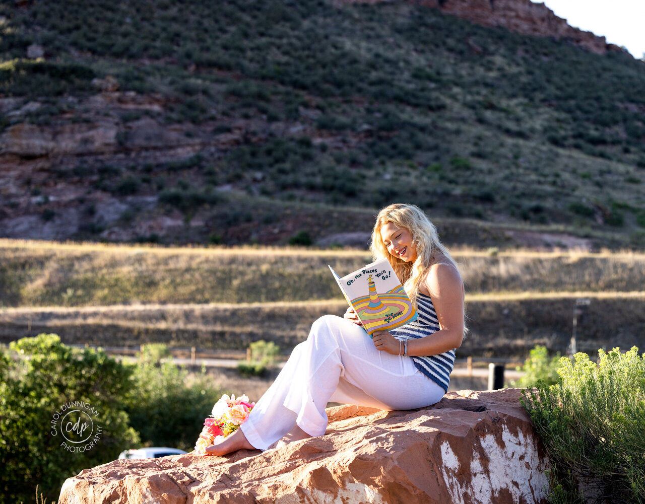 Jayda holding her Dr. Seuss book during her Loveland senior portrait session